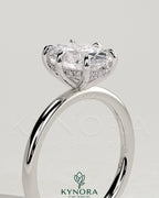 Kynora CJ 2ct oval claw solitaire engagement ring with hidden halo, featuring a sparkling center stone and intricate band design.