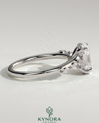 Kynora CJ 2ct oval claw solitaire engagement ring with hidden halo, opposing marquise accents, and cathedral high setting.