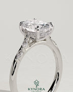 Kynora CJ 2ct oval claw solitaire engagement ring with hidden halo, marquise accents, and cathedral setting, showcasing intricate design.