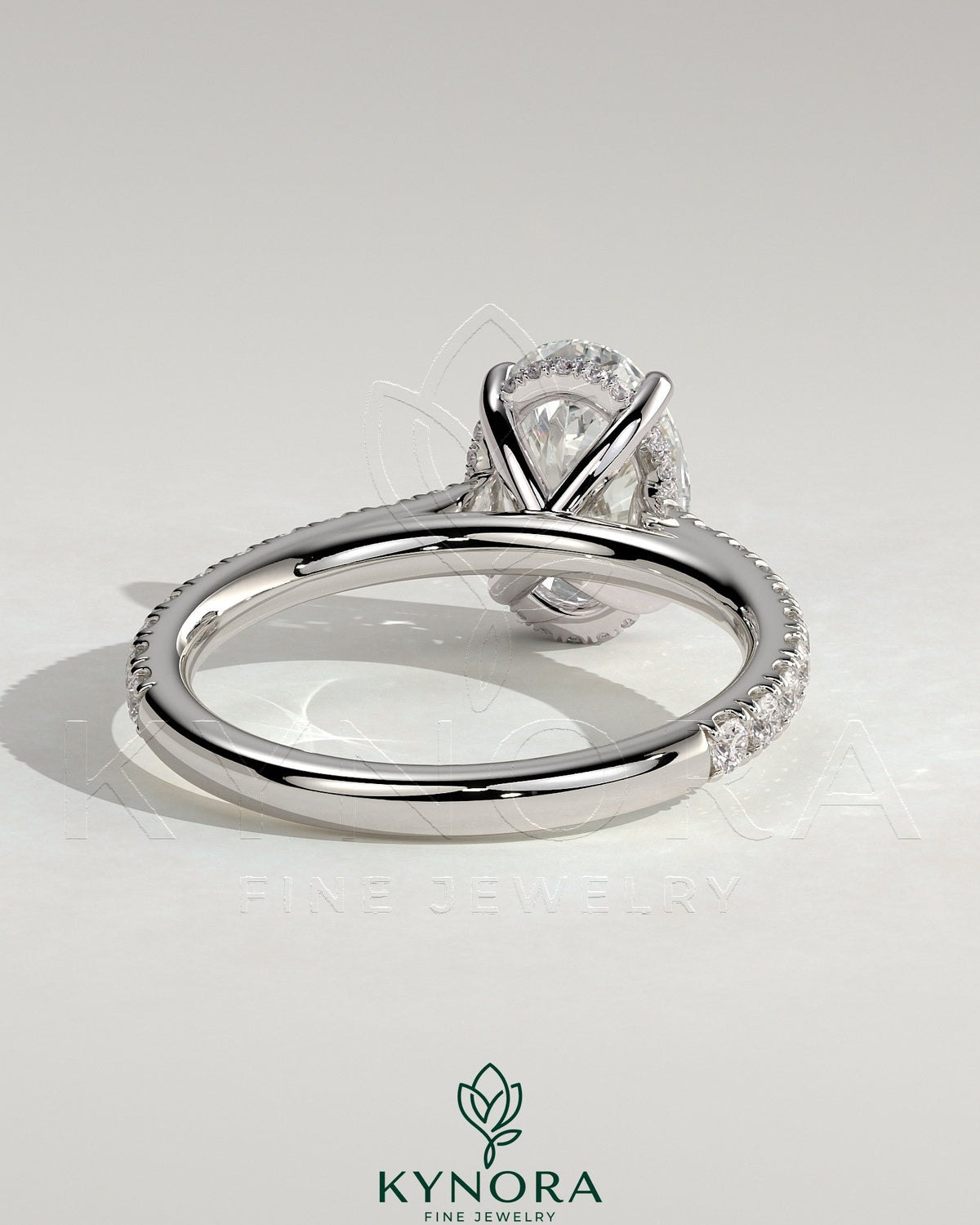 Kynora CJ 2ct oval claw solitaire engagement ring with hidden halo, pave band, and cathedral high setting.