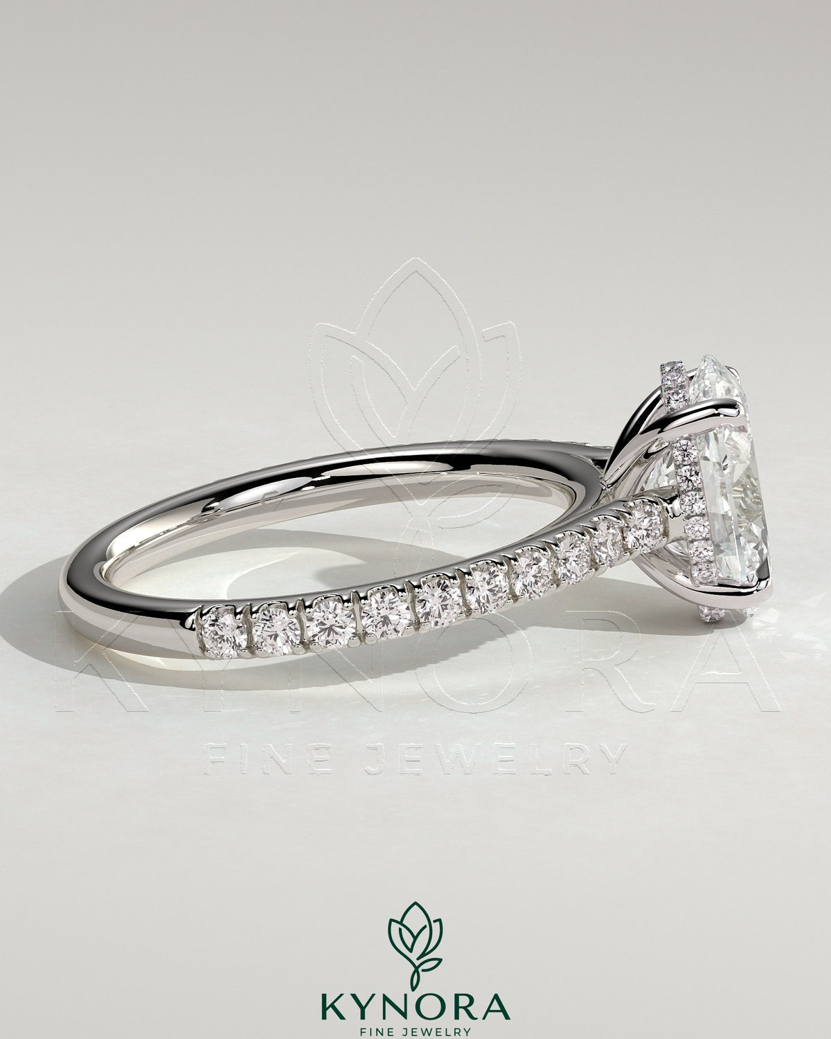 Kynora CJ 2ct oval claw solitaire engagement ring with hidden halo, pave band, and cathedral high setting, showcasing elegant jewelry design.