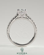 Kynora CJ 2ct oval claw solitaire engagement ring with hidden halo, pave band, and cathedral high setting, showcasing intricate details.