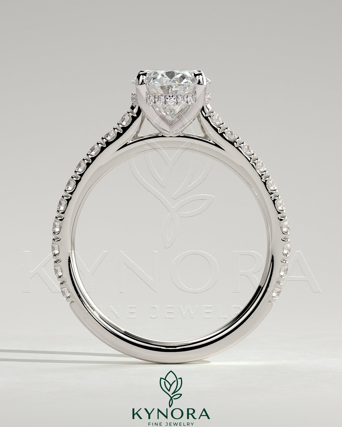 Kynora CJ 2ct oval claw solitaire engagement ring with hidden halo, pave band, and cathedral high setting, showcasing intricate details.