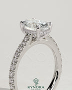 Kynora CJ 2ct oval claw solitaire engagement ring with hidden halo, pave band, and cathedral high setting in sterling silver.
