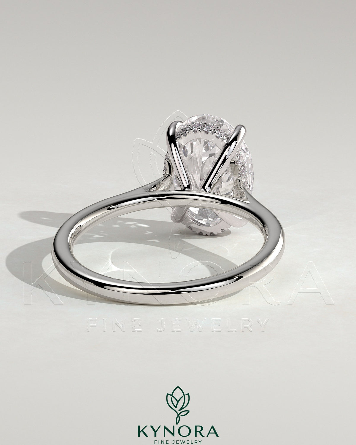 Kynora CJ 2ct oval claw solitaire engagement ring with hidden halo, tapered band, and cathedral high setting, showcasing intricate design.