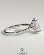 Kynora CJ 2ct oval claw solitaire engagement ring with hidden halo, tapered band, and cathedral high setting, showcasing elegant jewelry design.