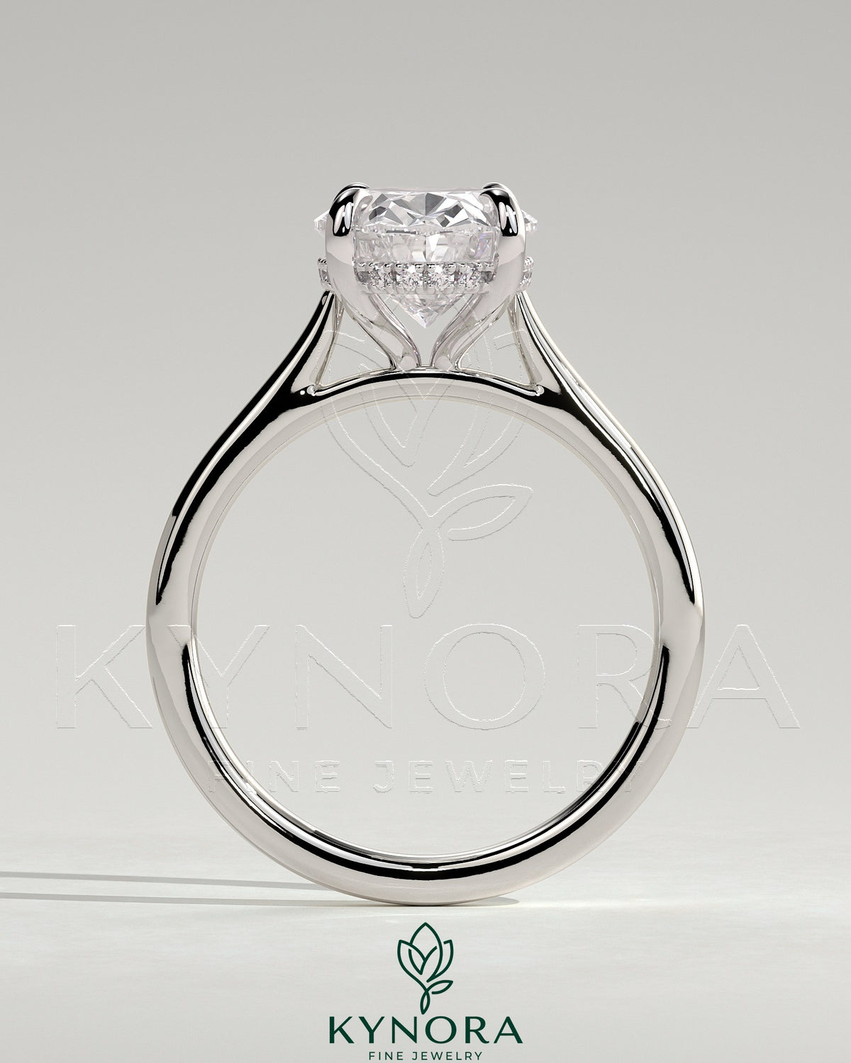 Kynora CJ 2ct oval claw solitaire engagement ring with hidden halo, tapered band, and cathedral high setting.