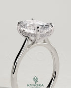 Oval 2ct solitaire engagement ring with hidden halo, tapered band, and cathedral high setting by Kynora CJ.