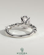 Kynora CJ 2ct oval claw solitaire engagement ring with marquise and round accent stones, showcasing sparkling diamond details.
