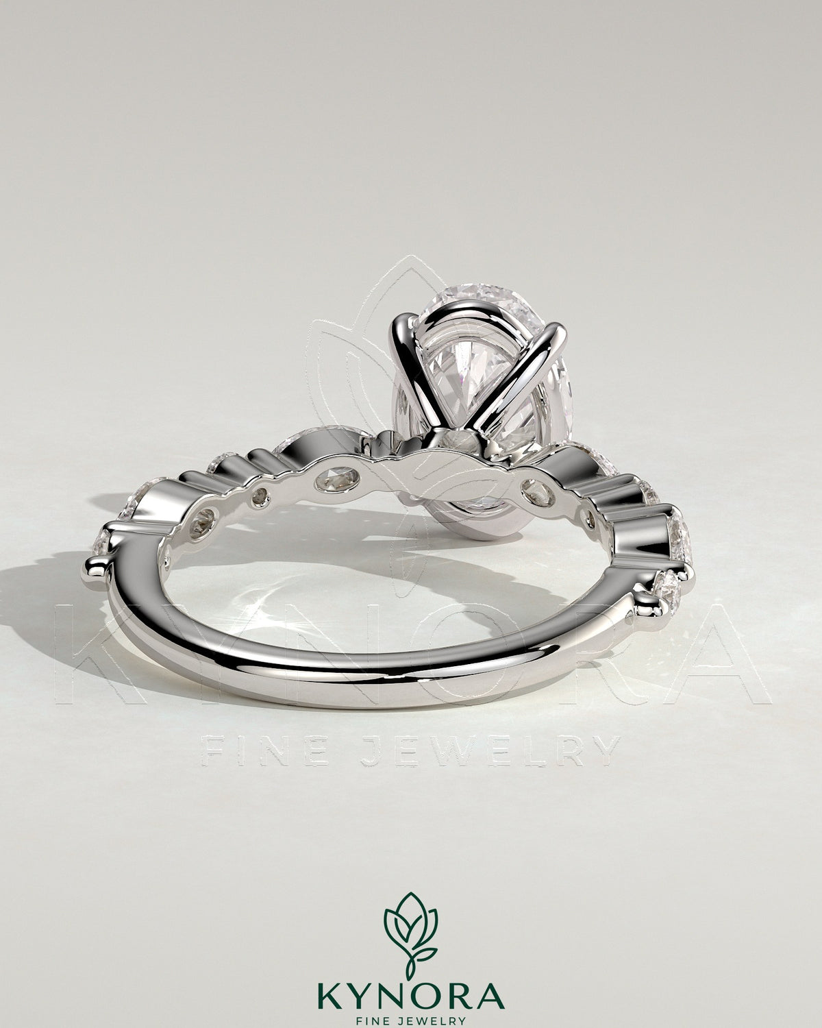 Kynora CJ 2ct oval claw solitaire engagement ring with marquise and round accent stones, showcasing sparkling diamond details.