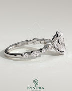 Kynora CJ 2ct oval claw solitaire engagement ring with marquise and round accent stones in a silver setting.