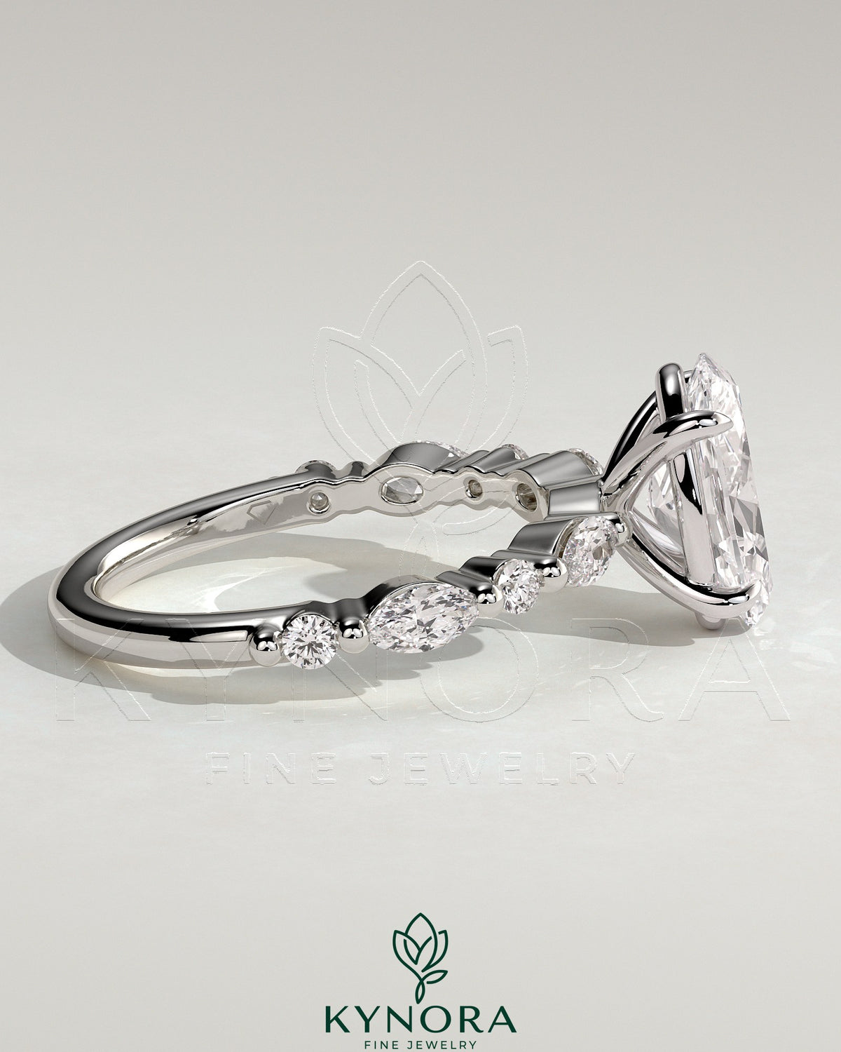 Kynora CJ 2ct oval claw solitaire engagement ring with marquise and round accent stones in a silver setting.