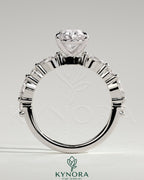 Kynora CJ 2ct oval claw solitaire engagement ring with marquise and round accent stones on a silver band.