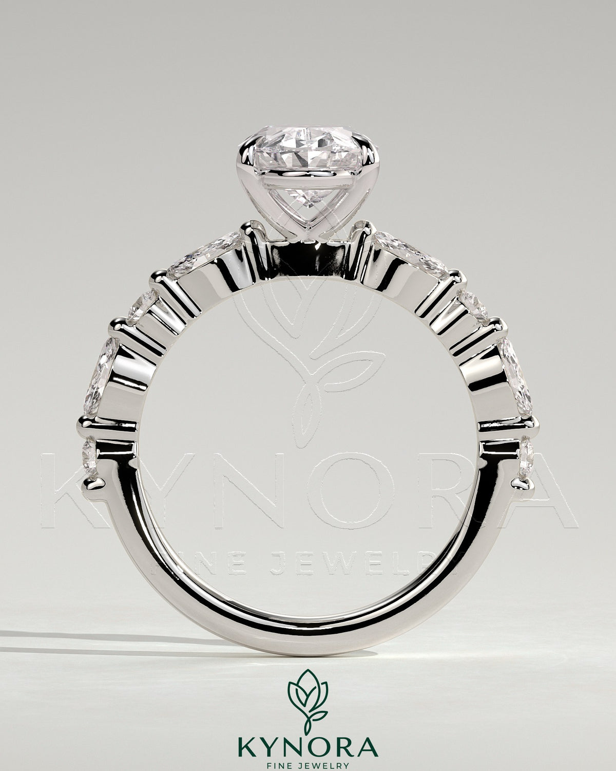 Kynora CJ 2ct oval claw solitaire engagement ring with marquise and round accent stones on a silver band.