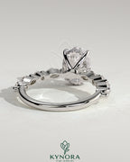 Kynora CJ 2ct oval claw solitaire engagement ring with marquise and round accent stones and hidden halo design.