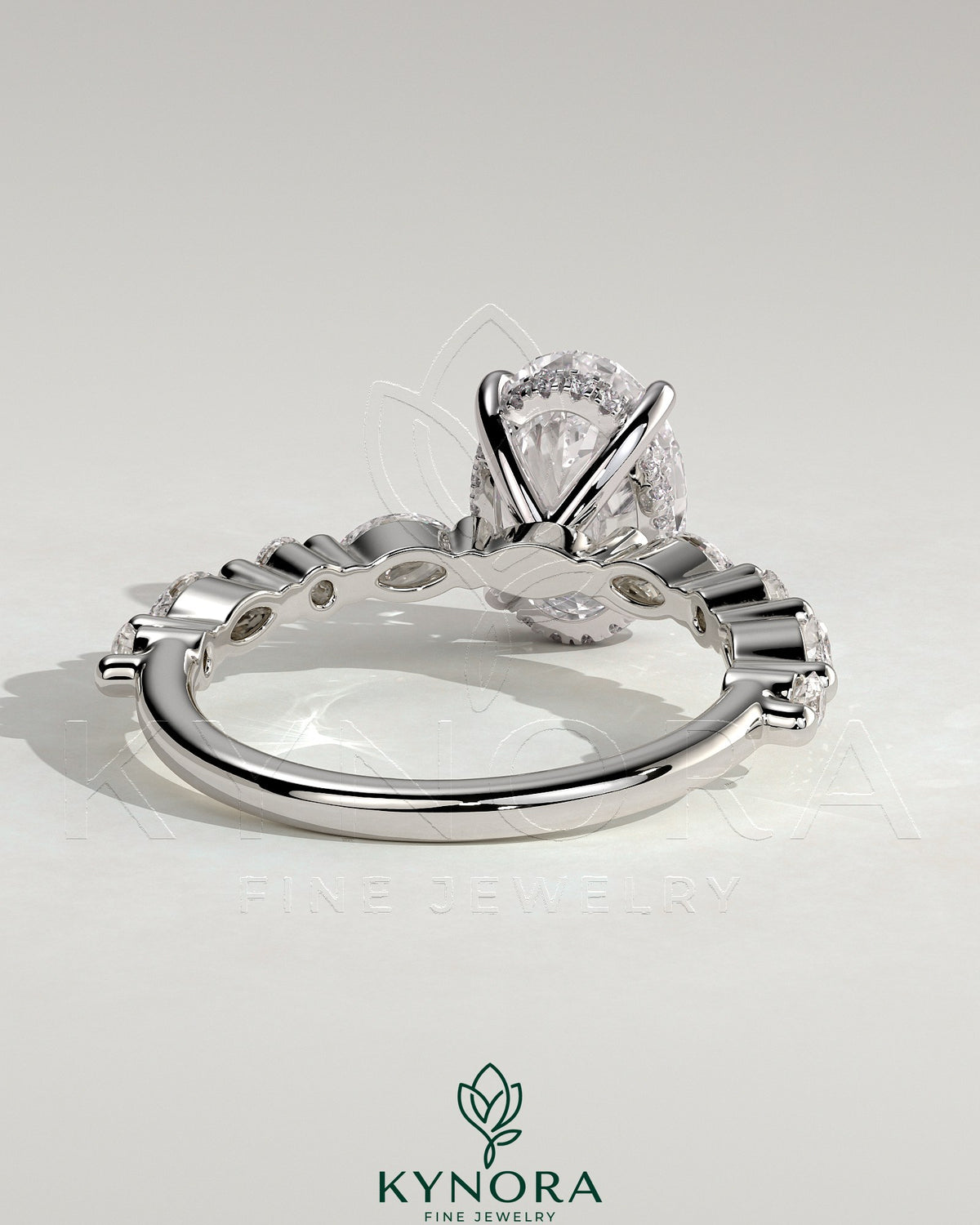 Kynora CJ 2ct oval claw solitaire engagement ring with marquise and round accent stones and hidden halo design.