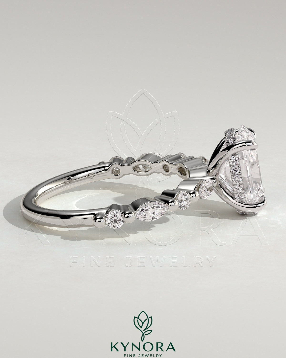 Kynora CJ 2ct oval claw solitaire engagement ring with marquise and round accent stones, featuring a hidden halo design.