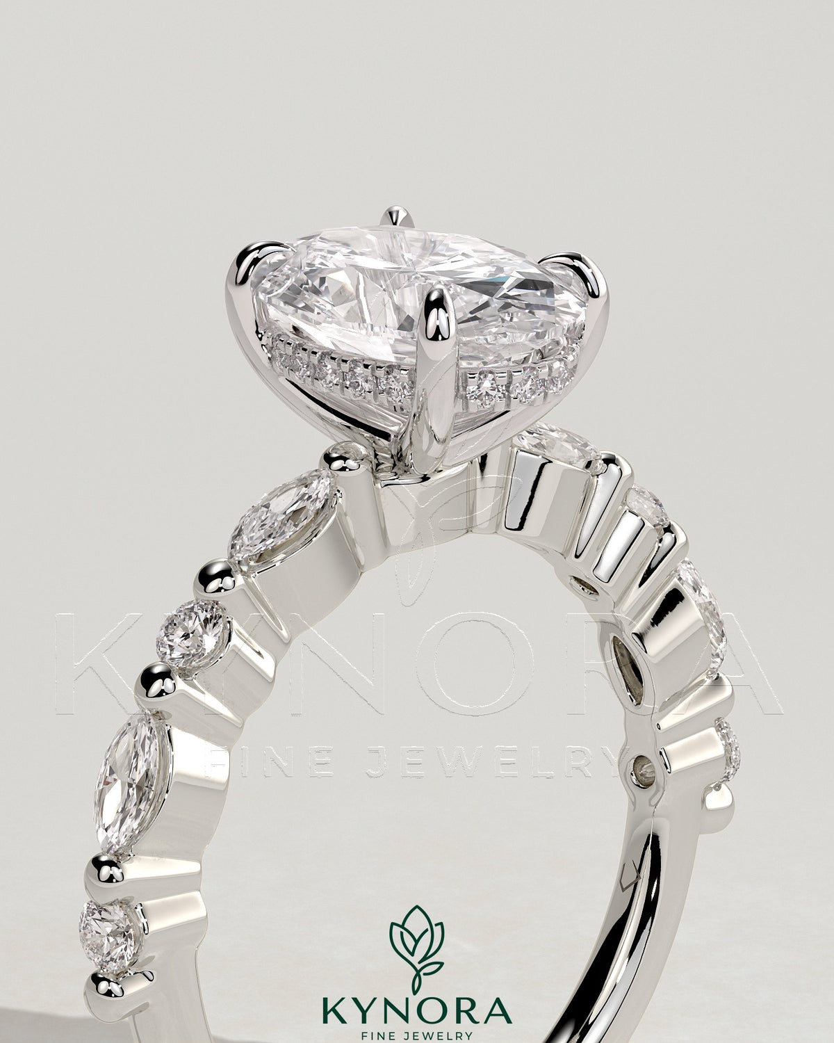 Kynora CJ 2ct oval claw solitaire engagement ring with marquise and round accents, hidden halo, and elegant gold band.