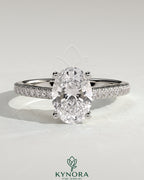 Kynora CJ 2ct oval claw solitaire engagement ring with pave band and cathedral low setting in shining gold.