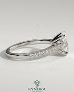 Kynora CJ 2ct oval claw solitaire engagement ring with pave band and cathedral low setting, showcasing elegant diamond craftsmanship.