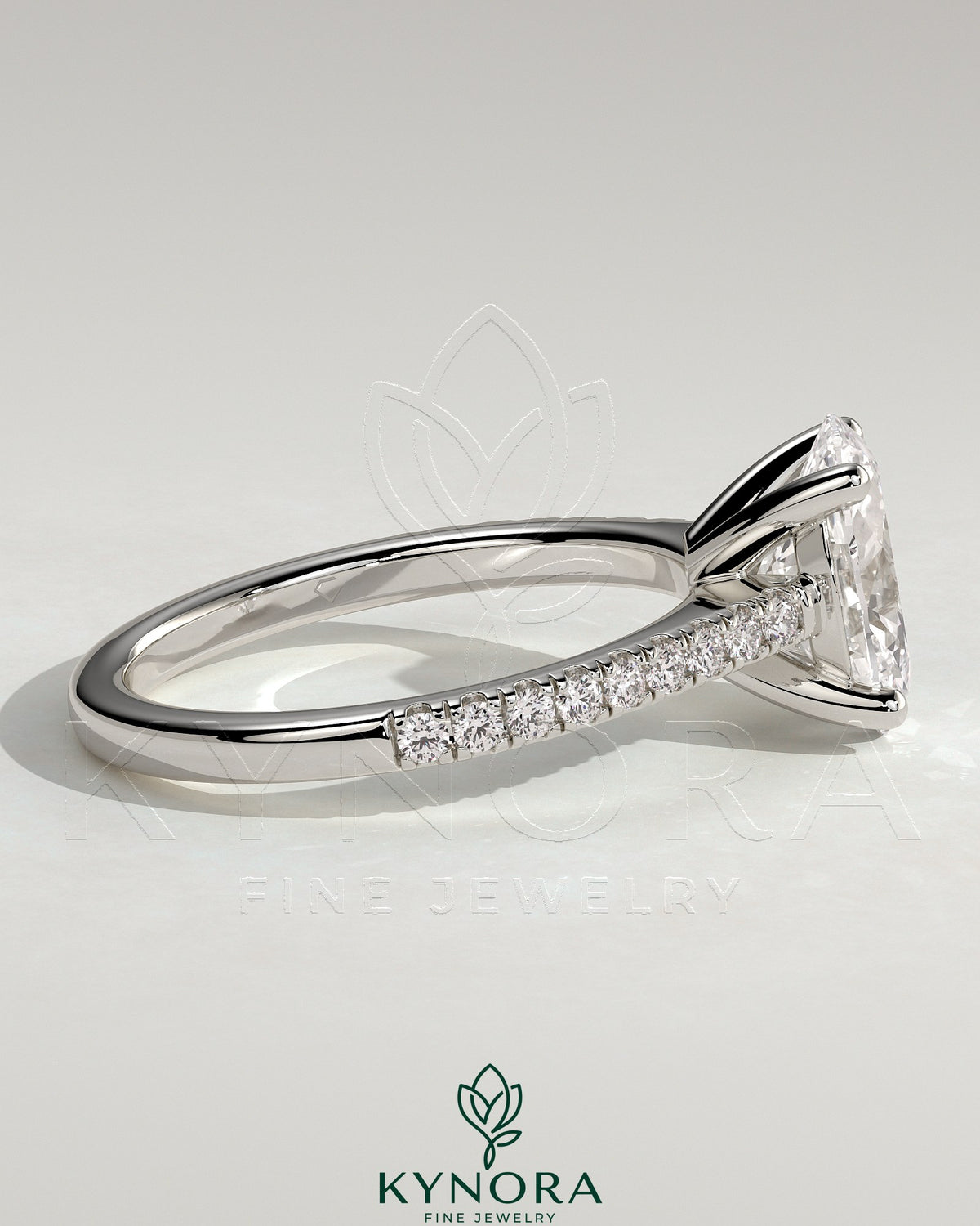 Kynora CJ 2ct oval claw solitaire engagement ring with pave band and cathedral low setting, showcasing elegant diamond craftsmanship.