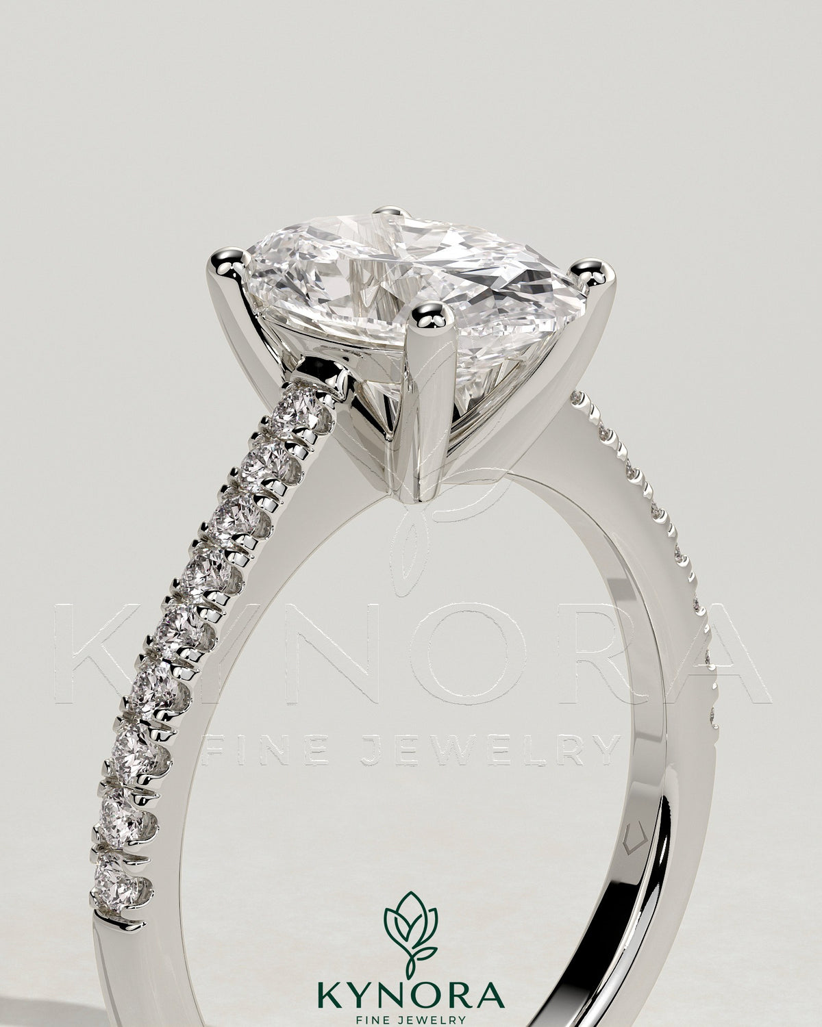 Kynora CJ 2ct oval claw solitaire engagement ring with pave band and cathedral low setting, showcasing elegant diamond design.