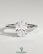 Kynora CJ 2ct oval claw solitaire engagement ring with petal gallery, leaf accents, and cathedral setting in gold.