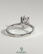 Kynora CJ 2ct oval claw solitaire engagement ring with petal gallery, leaf accents, and cathedral setting in polished gold