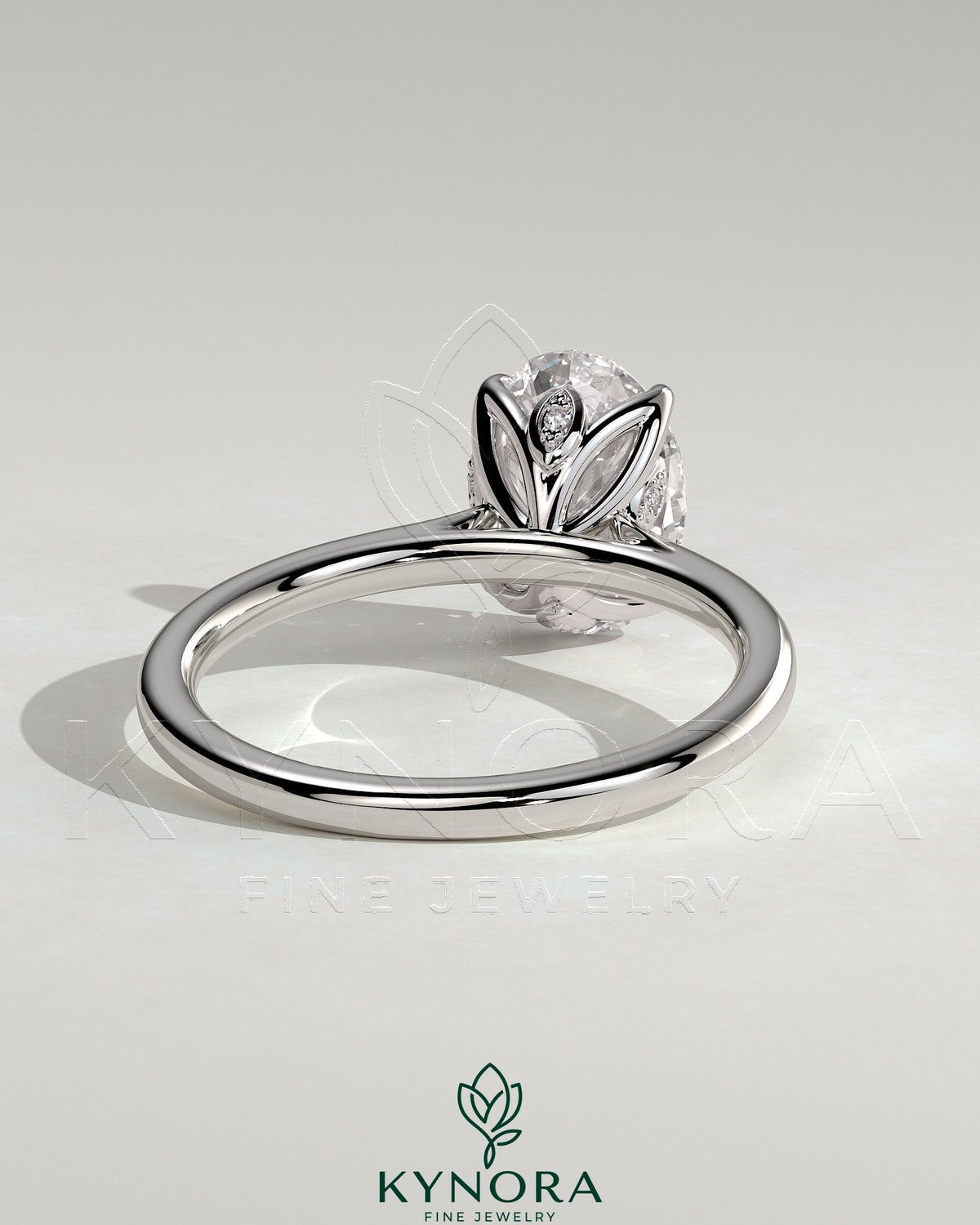 Kynora CJ 2ct oval claw solitaire engagement ring with petal gallery, leaf accents, and cathedral setting in polished gold