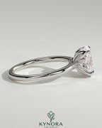Kynora CJ 2ct oval claw solitaire engagement ring with petal gallery, leaf accents, and cathedral setting in sterling silver.