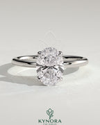 Kynora CJ 2ct oval claw solitaire engagement ring with petal gallery and leaf accents, showcasing intricate metalwork and a sparkling center stone.