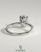 Kynora CJ 2ct oval claw solitaire engagement ring with petal gallery and leaf accents, crafted in elegant jewelry design.