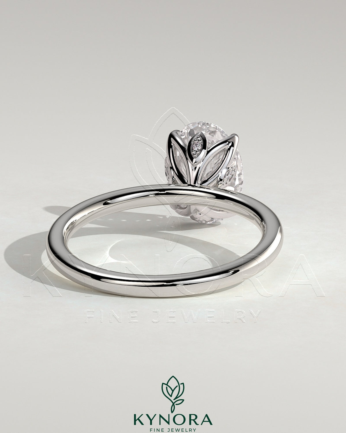 Kynora CJ 2ct oval claw solitaire engagement ring with petal gallery and leaf accents, crafted in elegant jewelry design.
