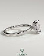 Kynora CJ 2ct oval claw solitaire engagement ring with petal gallery and accent leaf details, crafted in sterling silver.