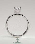 Kynora CJ 2ct oval claw solitaire engagement ring with petal gallery and accent leaf details, featuring a sparkling central diamond.