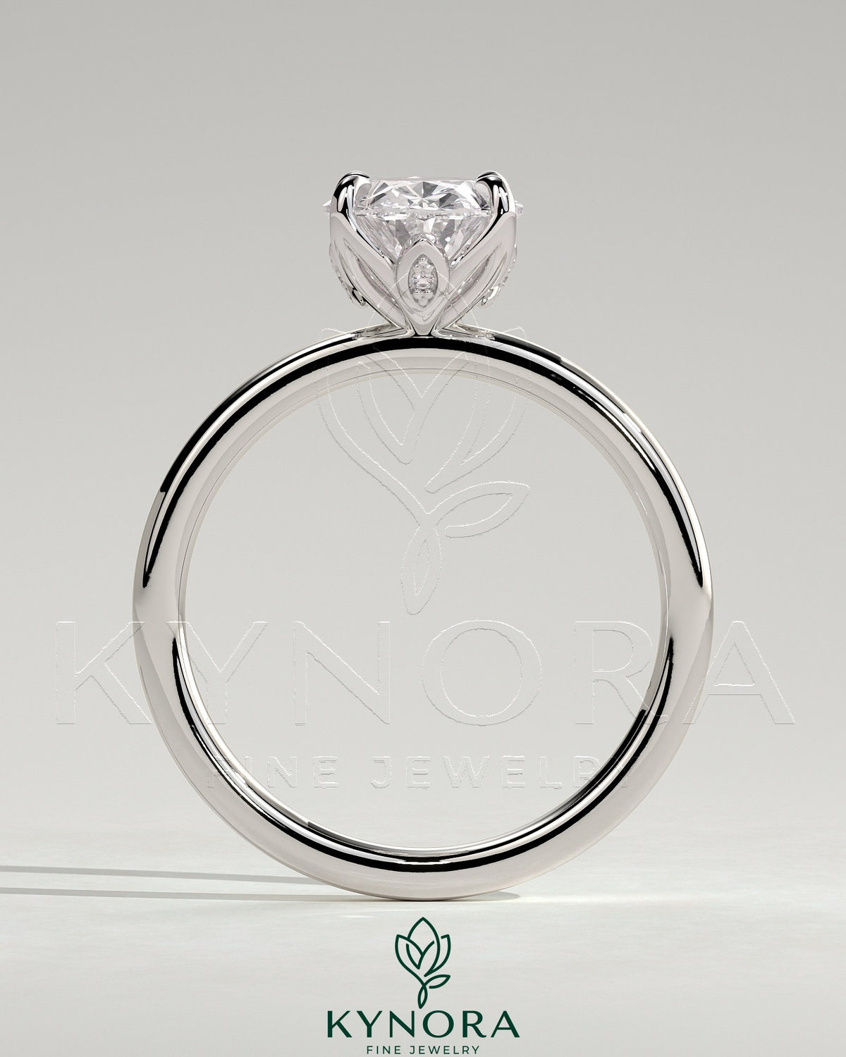 Kynora CJ 2ct oval claw solitaire engagement ring with petal gallery and accent leaf details, featuring a sparkling central diamond.