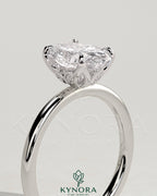 Kynora CJ 2ct oval claw solitaire engagement ring with petal gallery and accent leaf details in sterling silver.