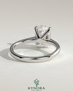 Kynora CJ 2ct oval claw solitaire engagement ring with pinched tapered band and cathedral low setting, crafted in gold.