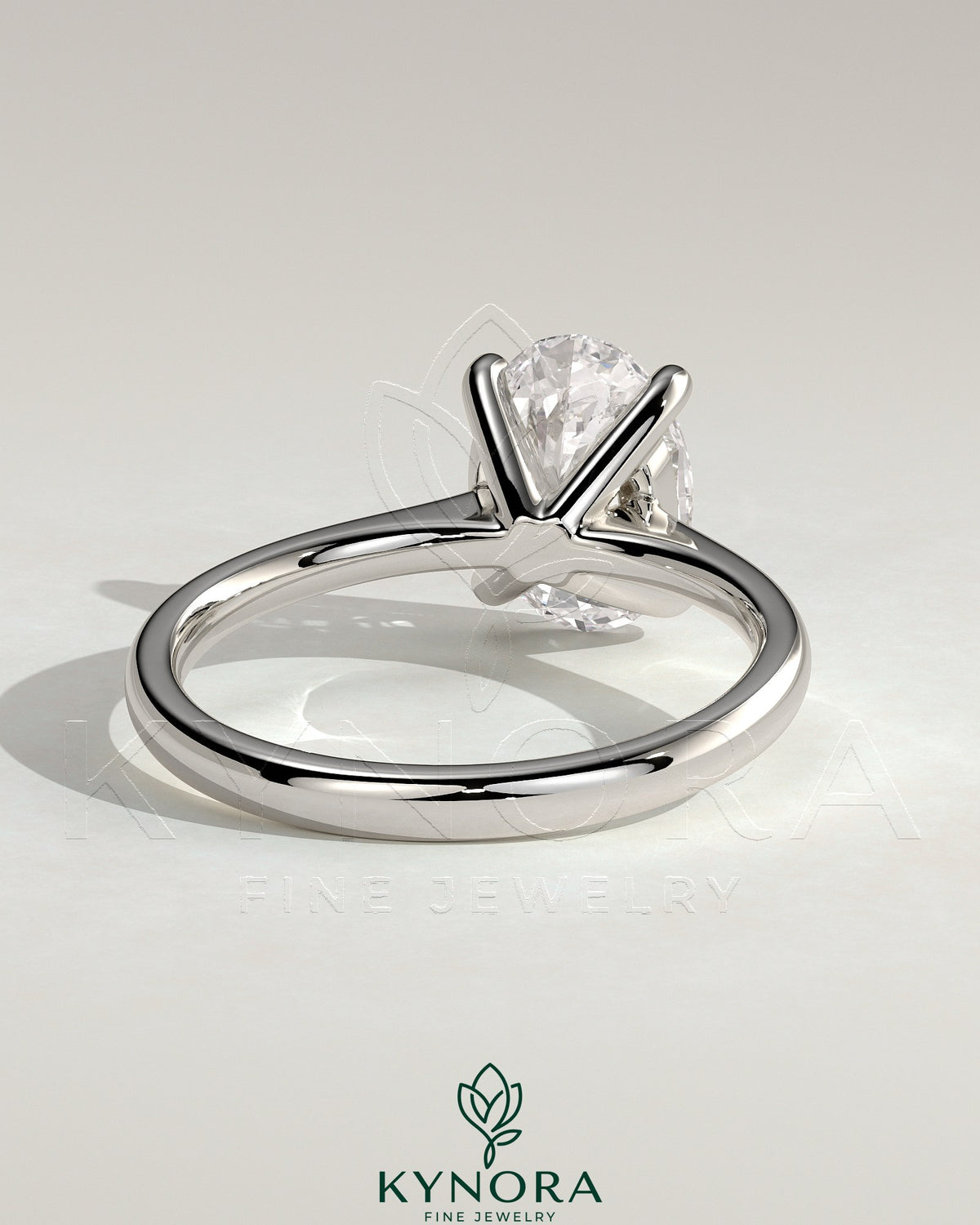 Kynora CJ 2ct oval claw solitaire engagement ring with pinched tapered band and cathedral low setting, crafted in gold.