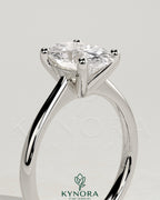 Kynora CJ 2ct oval claw solitaire engagement ring with pinched tapered band and cathedral low setting, showcasing elegant jewelry design.