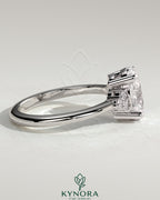 Kynora CJ 2ct oval claw solitaire engagement ring with round shoulder stones and intricate band design.