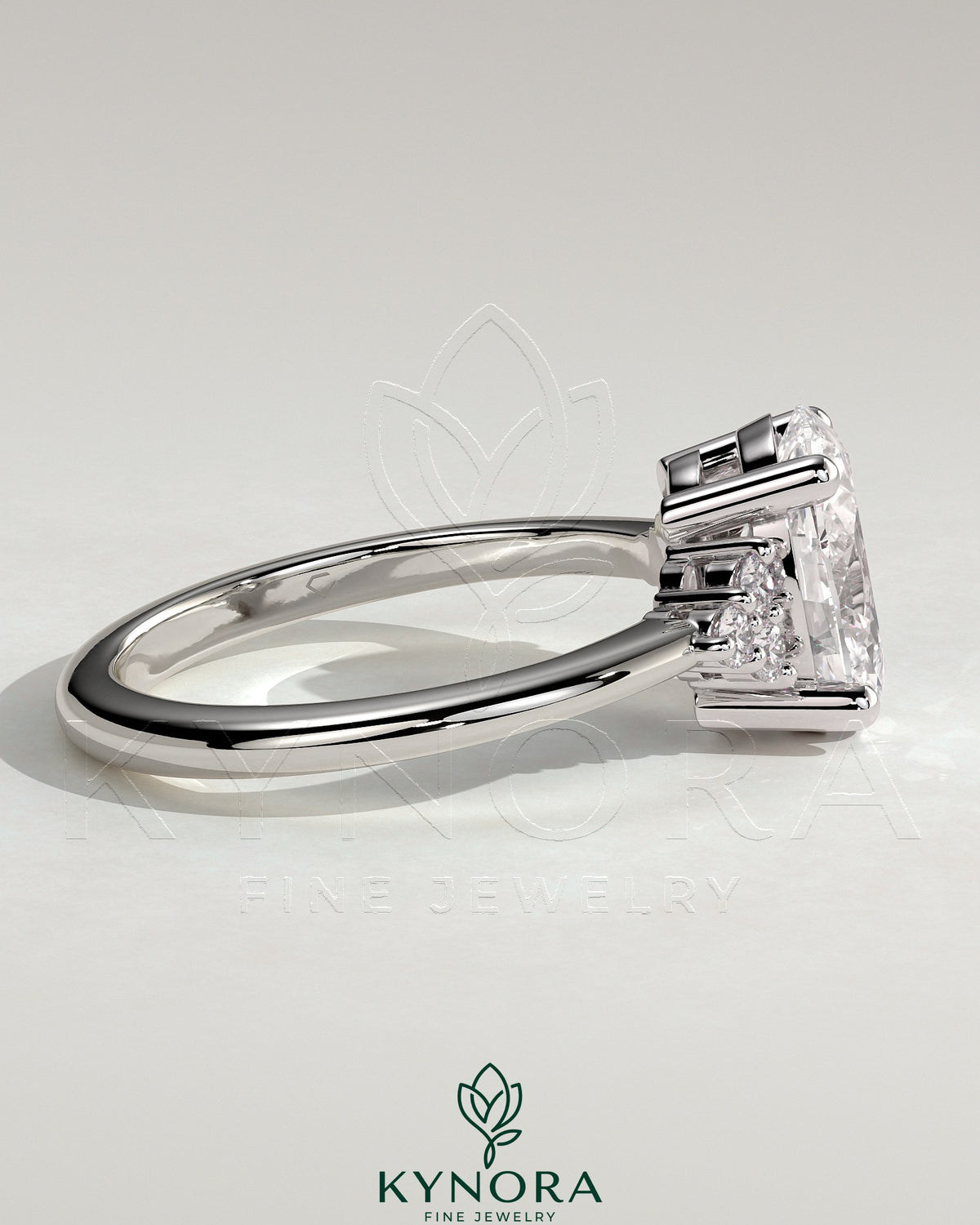Kynora CJ 2ct oval claw solitaire engagement ring with round shoulder stones and intricate band design.