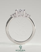 Kynora CJ 2ct oval claw solitaire engagement ring with round shoulder stones, showcasing a sparkling central diamond and intricate band.
