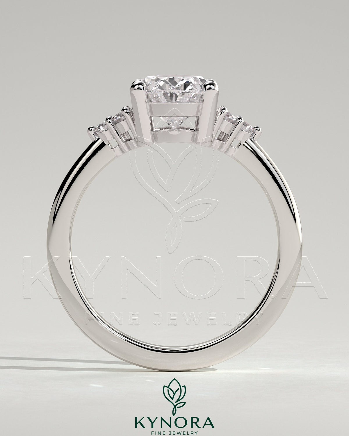 Kynora CJ 2ct oval claw solitaire engagement ring with round shoulder stones, showcasing a sparkling central diamond and intricate band.
