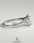 Kynora CJ 2ct oval claw solitaire engagement ring with split shank and cathedral high setting, showcasing elegant diamond design.