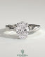 Kynora CJ 2ct oval diamond claw solitaire engagement ring with twisted band in silver setting on a white background.
