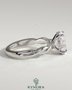 Kynora CJ 2ct oval claw solitaire engagement ring with twisted band, showcasing a sparkling oval diamond on a sleek gold band.