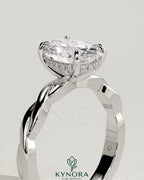Oval 2ct claw solitaire engagement ring with twisted band by Kynora CJ, featuring a sparkling oval diamond and intricate band design.