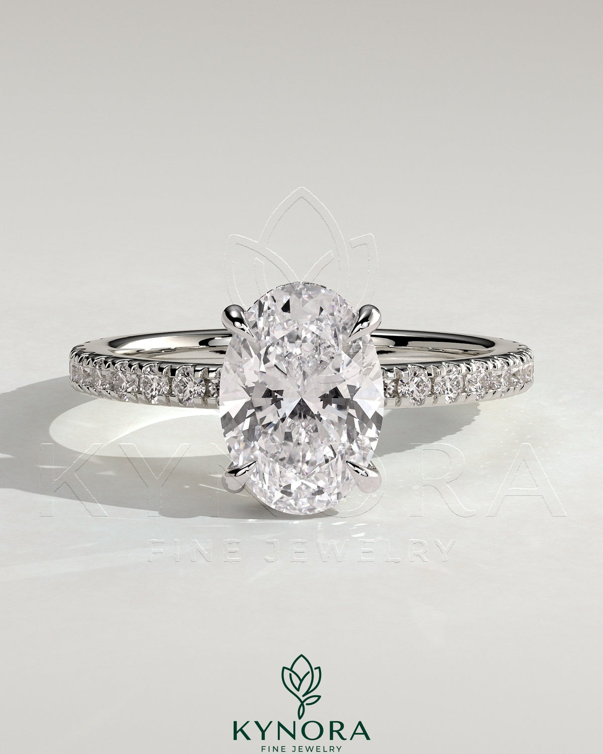 Kynora CJ 2ct oval claw solitaire engagement ring with wrap-around hidden halo and pavé band, showcasing elegant diamond setting. Main image