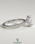 Kynora CJ 2ct oval claw solitaire engagement ring with hidden halo and pave band, showcasing elegant diamond setting and craftsmanship.